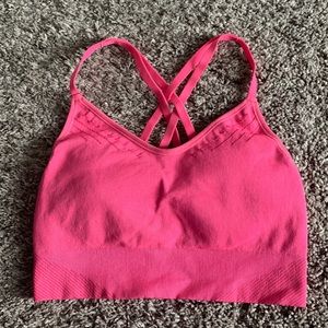 Hot pink sports bra with crisscross straps and removable padding